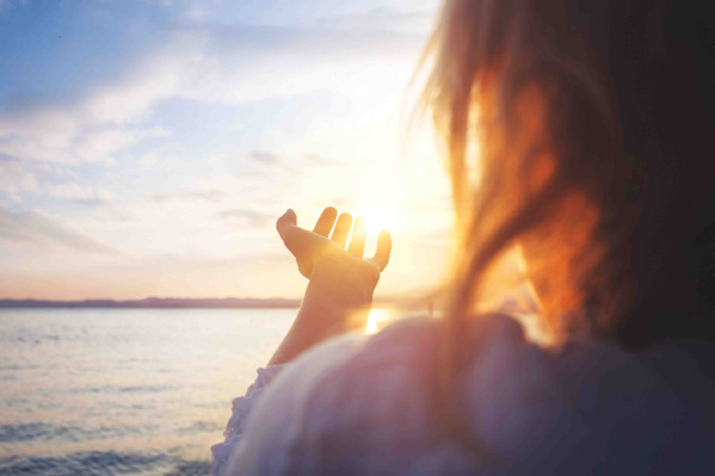 woman try to grab the sun happy love yoga