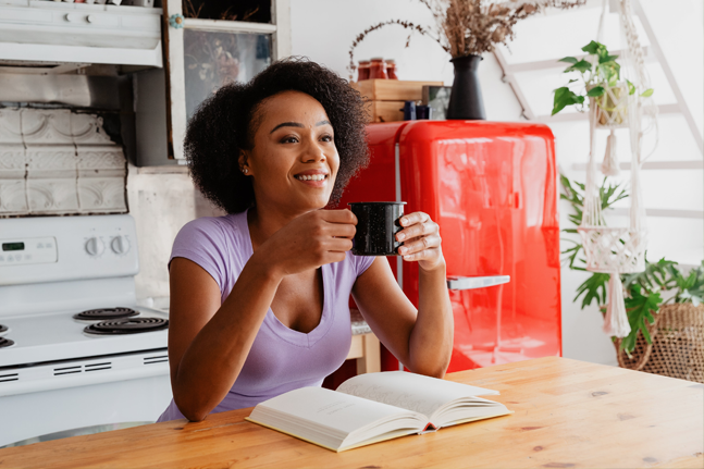 Worry Free Woman In Kitchen With Book Sarah Pflug